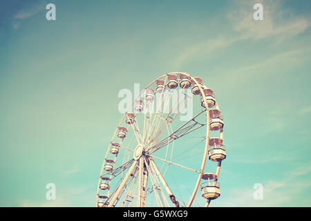 Retro toned picture of a Ferris wheel at sunset. Stock Photo