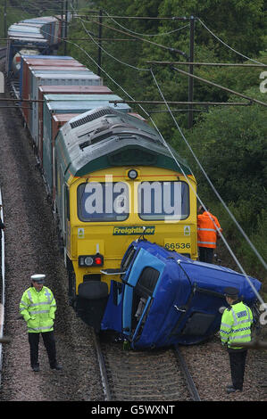 The scene in Lawford, near Manningtree, Essex, after a freight train smashed into the cab of a lorry that had overturned and separated from the main chassis of the vehicle. * A British Transport Police spokesman said the driver of the lorry was hurt in the incident, although it was not immediately clear how seriously. Local people who went to the scene near Manningtree, Essex, said the emergency services were called after the lorry ended up on the track. But the train then arrived and crashed into the part of the lorry that had fallen on the line. Stock Photo