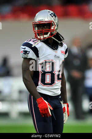 New England Patriots wide receiver DeVante Parker (1) catches the ball as  he practices on the field before an NFL football game against the Miami  Dolphins Sunday, Sept. 11, 2022, in Miami