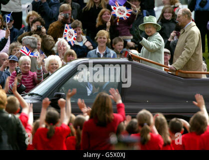 Britain's Queen Elizabeth and the Duke of Edinburgh wave at gathered crowds at Melrose rugby ground in the Scottish Borders. It is the last day of the Queen's Golden Jubilee visit to Scotland. Stock Photo