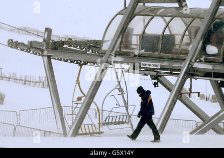 People walk past the the ski lift where an accident occurred further up the hill at the Lecht ski centre near Tomintoul. Stock Photo