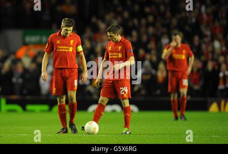 Liverpool's Steven Gerrard (left), Joe Allen (centre) and Jamie Carragher stand dejected after conceeding Stock Photo