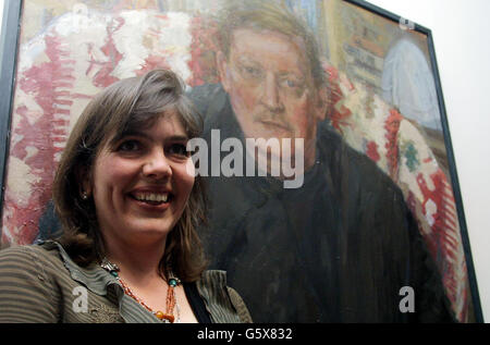 Artist Catherine Goodman stands in front of her winning portrait entitled 'Antony', after she picked up the first prize at the BP Portrait Awards at the National Portrait Gallery in London. Goodman picked up 25,000 for a painting of her friend Antony Sutch. *..., who is headmaster of Downside School in Somerset. Stock Photo