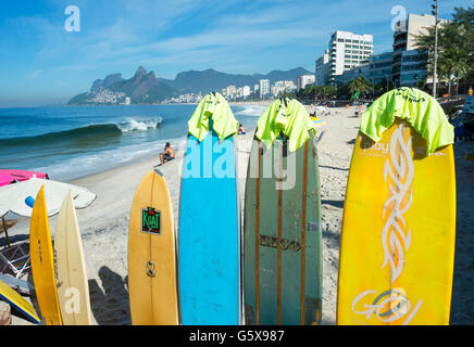 RIO DE JANEIRO - MARCH 30, 2016: Colorful surfboards stand lined up on the beach at Arpoador, a popular surf destination. Stock Photo