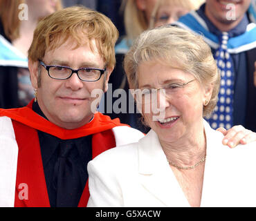 Sir Elton John with his mother, smiles after receiving an Honorary Doctorate from the Royal Academy of Music outside the Royal Academy of Music in London. * Sir Elton who studied at the Academy was accompanied by his partner David Furnish and his parents mother Sheila and stepfather Fred Fairbrother. Stock Photo