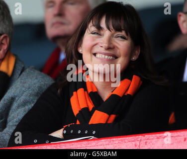 TV presenter Lorraine Kelly smiles as she sits in the stands during the Scottish Cup, Sixth Round at Dens Park, Dundee. Stock Photo