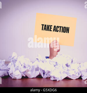 HAND HOLDING YELLOW PAPER WITH TAKE ACTIONCONCEPT Stock Photo