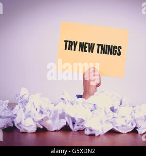 HAND HOLDING YELLOW PAPER WITH TRY NEW THINGSCONCEPT Stock Photo