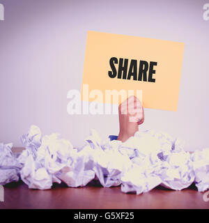 HAND HOLDING YELLOW PAPER WITH SHARECONCEPT Stock Photo