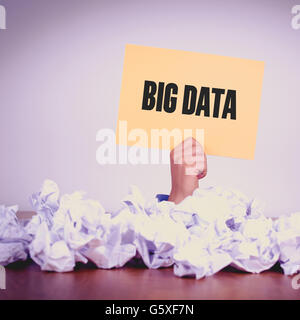 HAND HOLDING YELLOW PAPER WITH BIG DATACONCEPT Stock Photo