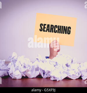 HAND HOLDING YELLOW PAPER WITH SEARCHINGCONCEPT Stock Photo