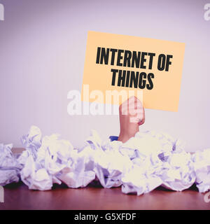 HAND HOLDING YELLOW PAPER WITH INTERNET OF THINGSCONCEPT Stock Photo