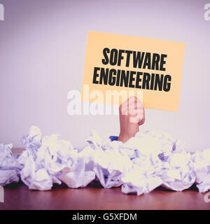 HAND HOLDING YELLOW PAPER WITH SOFTWARE ENGINEERINGCONCEPT Stock Photo