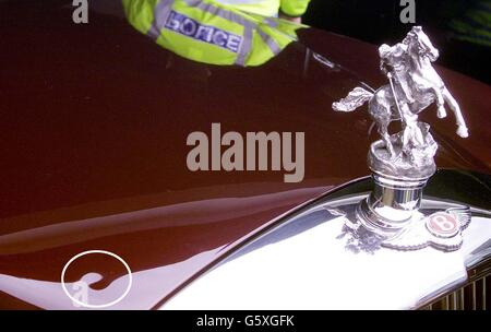 The bump on the bonnet of Britain's Queen Elizabeth II's Bentley car at Epsom. Despite only having its first run-out during the Golden Jubilee celebrations last week, the limousine, estimated to have cost about 5 million in research and development, already has a dent in it. * It is the Queen's first state limousine for state and ceremonial occasions for 15 years and was developed by a collaboration of about 50 firms. The car is powered by a 400bhp twin turbo 6.75 litre V8 engine and is capable of running on liquid petroleum gas. The Queen was at the racecourse to watch the Vodafone Derby. Stock Photo