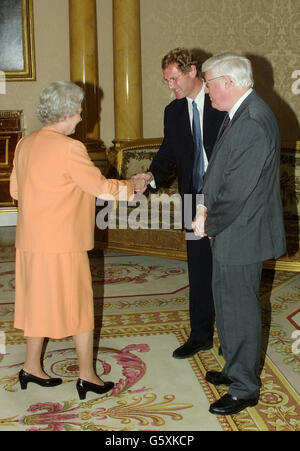 Britain's Queen Elizabeth II greet Poet Laureate Andrew Motion, before presenting Peter Porter (right) with her Gold Medal for Poetry at Buckingham Palace in London. Born in Brisbane, Australia, in 1929, he has been writing poetry since he left school. * In 1983, he won the Duff Cooper Memorial Prize for his first book of collected poems and in 1988 he won the Whitbread Poetry Award for the Automatic Oracle. The Gold Medal for Poetry was instituted by King George V in 1933 at thesuggestion of the then Poet Laureate, Dr John Masefield. Stock Photo