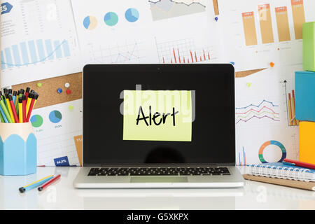 ALERT sticky note pasted on the laptop screen Stock Photo