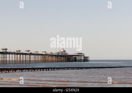 The victorian pier stretching out to sea at Llandudno taken in evening light. Stock Photo