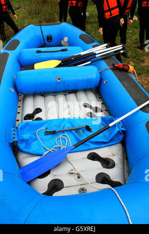 Recreational inflatable white rubber raft with an outboard motor tied ...