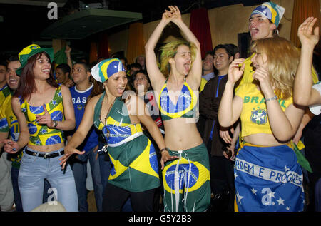 Brazilian Football fans at the Bar Madrid in central London celebrate celebrate their country's 2-1 win against England in the World Cup quarter final in Japan. Stock Photo