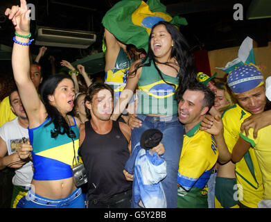 Brazilian soccer fans at the Bar Madrid in central London celebrate, their country's 2-1 win against England in the World Cup quarter final in Japan. Stock Photo