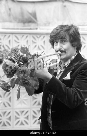 Jazz musician Kenny Ball plays his trumpet at the opening of the Chelsea Flower Show, where a new rose called the Trumpeter was on display. Stock Photo