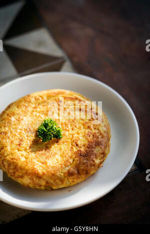 tortilla traditional spanish simple tapas egg omelet on spain rustic style tiles Stock Photo
