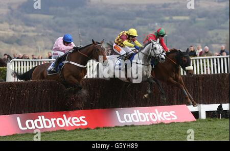 (left to right) Captain Conan ridden by Barry Geraghty, Dynaste ridden by Tom Scudamore and eventual winner Benefficient ridden by Bryan Cooper jump the fence during the Jewson Novices' Chase, on St Patrick's Thursday, during Cheltenham Festival. Stock Photo