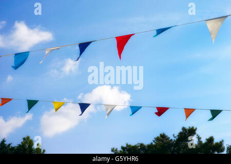 Colorful decoration flags against blue sky background. Stock Photo