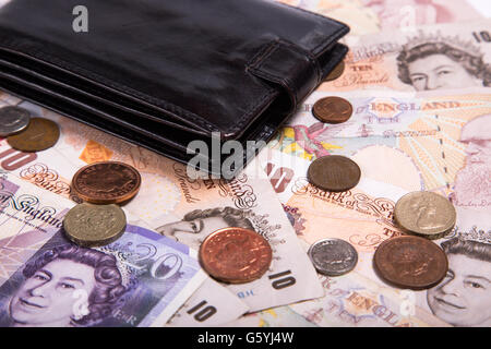 Pound money and black wallet background Stock Photo