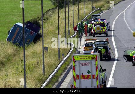 Emergency Services personnel at the the scene of the crash on the M4 motorway near Reading, Berkshire, where at least 31 people were injured when their coach overturned after colliding with a car. Stock Photo