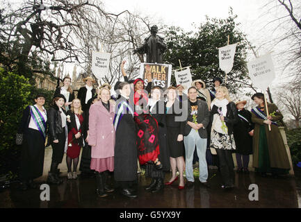 (Centre left to right) Helen Pankhurst (in black wearing blue sash, the granddaughter of suffragette Sylvia Pankhurst and great-grandaughter of Emmeline Pankhurst), Somali women's rights activist Zenab Abdi, Laura Pankhurst (daughter of Helen) and Minister for Women and Equalities Maria Miller MP during a photocall to mark International Women's Day, at Victoria Tower Gardens in central London. Stock Photo