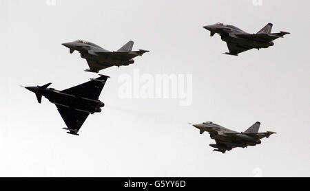 Four RAF Eurofighters fly over Farnborough Airshow in a display before the plane was officically named Typhoon by the Defence Minister Geoff Hoon. The first Typhoon is due to be delivered to the RAF by the end of this year. *...Mr Hoon, accompanied by the Chief of the Air Staff, Air Chief Marshall Sir Peter Squire and the Chief of Defence Procurement, Sir Robert Walmsley, met Typhoon's air crew, Craig Penrice and Wing Commander David 'Charlie' Chan after the aircraft took part in a formation flypast. Stock Photo