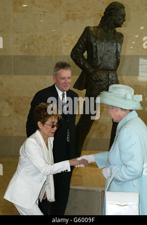 Britain's Queen Elizabeth II talks with Yoko Ono, in front of a statue - designed by Tom Murphy (centre) - of her husband, former Beatle John Lennon. *They met when the Queen was opening Liverpool's John Lennon Airport as she continued her Jubilee tour of the North West. Later in the day she was due to open the Commonwealth Games in Manchester. Stock Photo