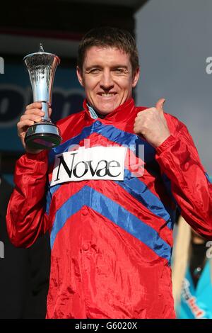 Jockey Barry Geraghty celebrates his victory with Sprinter Sacre in the Sportingbet Queen Mother Champion Chase on Ladies Day, during the Cheltenham Festival. Stock Photo