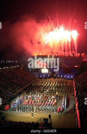 Fireworks explode above the castle as Queen Elizabeth II attends a performance of the Edinburgh Military Tattoo at Edinburgh Castle. 27/07/04: Details of the full programme will be formally announced in the capital. The 55th annual Tattoo is set to be a truly international affair with more than a thousand performers from around the globe taking part. The event will feature the largest single gathering of military musicians in the UK and acts from as far afield as South Africa, New Zealand and the Far East. Stock Photo