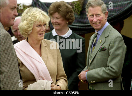 The Prince of Wales with companion Camilla Parker Bowles watches from the Royal tent , the Highland games in Mey nr Wick in Scotland. Stock Photo
