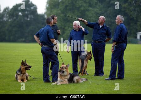 Police dog team search the playing fields of Soham Village College while police question the caretaker and his partner over the missing 10-year-old girls Jessica Chapman and Holly Wells in Soham Cambridhgeshire. Stock Photo