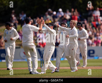 New Zealand's Tim Southee (second left) is congratulated by captain Brendon McCullum after running out England's Joe Root (not pictured) during Day Five of the First Test at the University Oval, Dunedin, New Zealand. Stock Photo