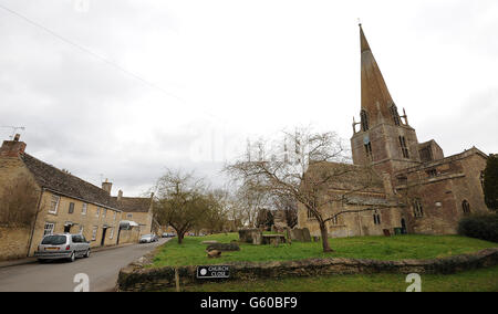 General view of St Marys Church in Bampton Village in Oxfordshire which is transferred into St. Michael of All Angels when Bampton is changed into the fictional village of Downton a few weeks a year when filming takes place.A house which is turned into the 'Grantham Arms' can be seen left Stock Photo