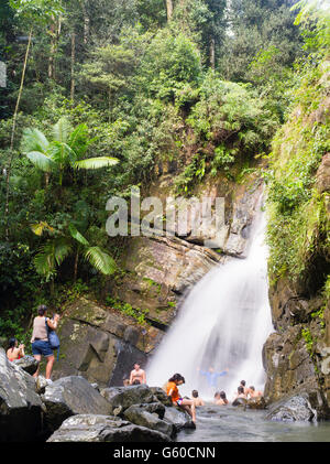 People enjoy cooling off in La Mina Falls, El Yunque Falls, Puerto RIco. Stock Photo