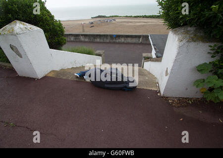 Passed out unconscious,  man on seafront, lying on pavement, Clacton Essex Stock Photo