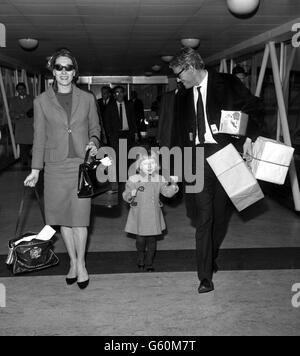 Irish actor Peter O'Toole, who in the past week has twice collapsed in New York where he has been for television appearances pictured on his arrival from New York at London Airport with his wife Sian, and daughter Kate, 4. Doctors believe Mr O'Toole is suffering from extreme exhaustion due to over work and too much travelling. Stock Photo