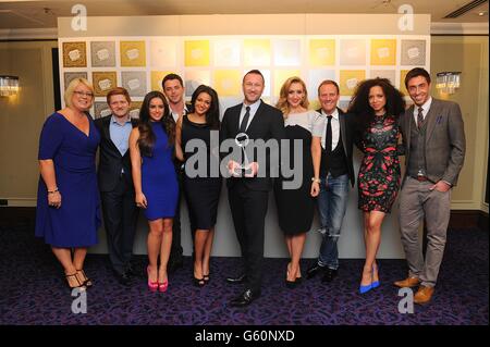 Coronation Street cast Sam Aston, Michelle Keegan, Georgia May Foote, Natalie Gumede, Catherine Tyldesley, Antony Cotton and the production team with the award for TV Soap Of The Year at the 2013 TRIC Awards, at Grosvenor House on Park Lane, London. Stock Photo