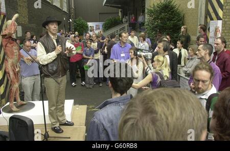 Professor Gunther Von Hagens (left, in hat) with one of his exhibits (far left), outside the 'Body Worlds' show where there was a demonstration at the Atlantis gallery in Brick Lane, East London. The Professor was defending his show. *... which uses dead bodies stripped of their skin, to show the inner workings of the human anatomy. The controversial show has attracted 220,000 visitors in London alone, but has also attracted widespread criticism from protest groups. Stock Photo