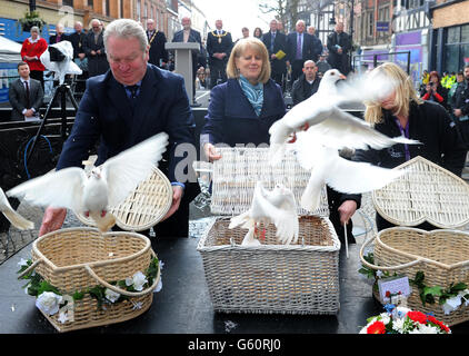 Wendy Parry, the mother of Tim Parry, releases doves with Mike Penning (left) MP, Minister of State for Northern Ireland, during a ceremony to mark the 20 year anniversary of the Warrington Bomb, Bridge Street, Warrington. Stock Photo