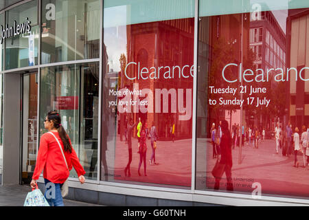 Passer-by John Lewis store in Liverpool One retail hub as it stages its summer clearance sale. Merseyside, UK Stock Photo