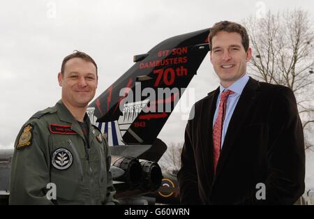 Historian and television presenter Dan Snow (right) alongside Squadron Leader Mark Still unveils the 70th anniversary 'Dambuster' painted RAF Tornado jet at RAF Coningsby in Lincolnshire. Stock Photo