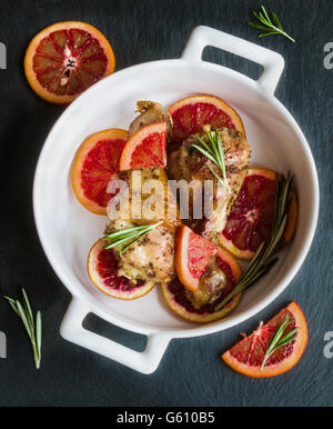 slices of oranges in white dish on dark wooden table Stock Photo - Alamy