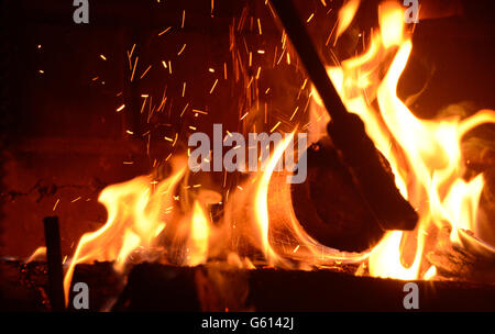 Log with flames in fireplace Stock Photo
