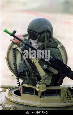 A British Army Desert Rat in the turret of a tank wearing mask and goggles as protection against the sand and dust of the Saudi Arabian desert. Stock Photo